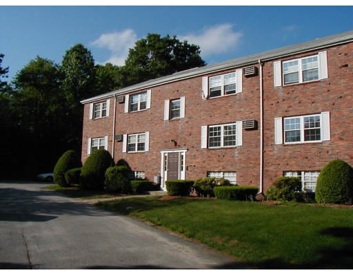 Front view of a two-story brick building with multiple windows and a central entrance.