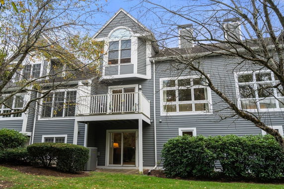 Front view of a multi-story house with a gray exterior and white trim.