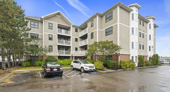 Front view of a multi-story residential building with balconies.