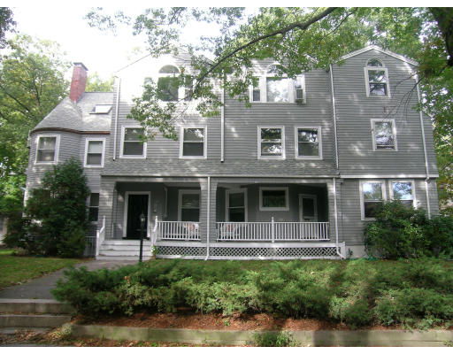 Front view of a multi-story house with a prominent front porch.