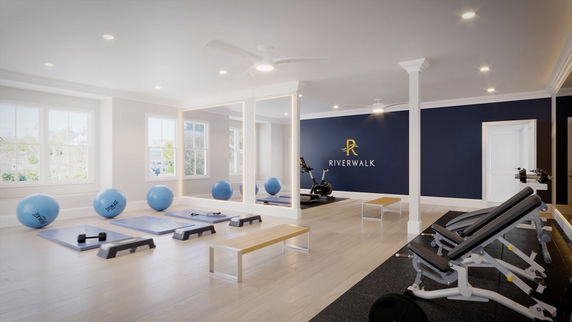 Indoor fitness area with exercise equipment and mirrored wall.