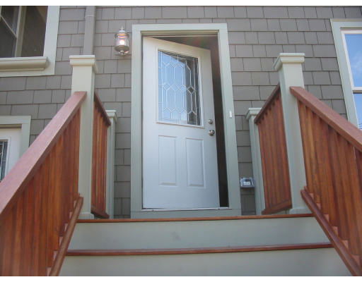 Front view of a house with a single door and staircase.