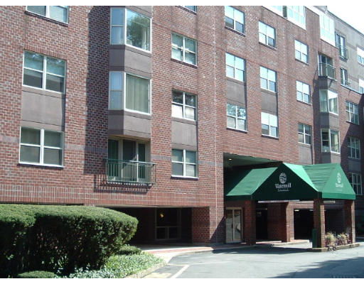 Front view of a multi-story brick apartment building.