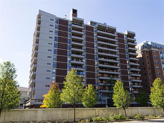 Front view of a multi-story residential building with balconies.