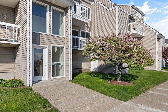 Front view of a multi-story residential building with balconies.
