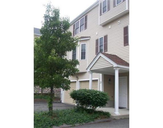 Front view of a multi-story residential building with a covered entrance.