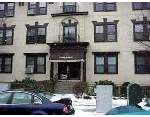 Front view of a multi-story building with a central entrance.