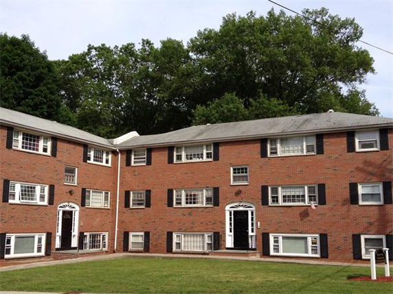 Front view of a three-story brick apartment building.