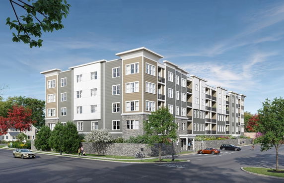 Front view of a multi-story apartment building with a modern design and large windows.