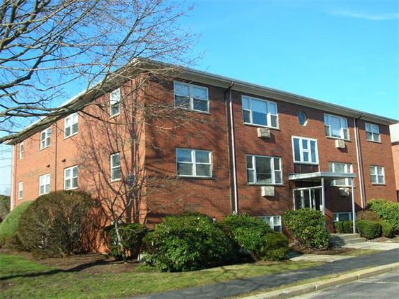 Front view of a three-story brick apartment building.