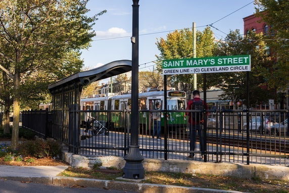 Outdoor view of a tram stop with a green line train at Saint Mary's Street.
