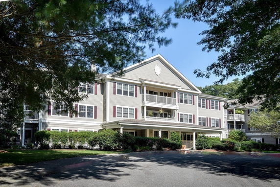 Front view of a three-story residential building with balconies.