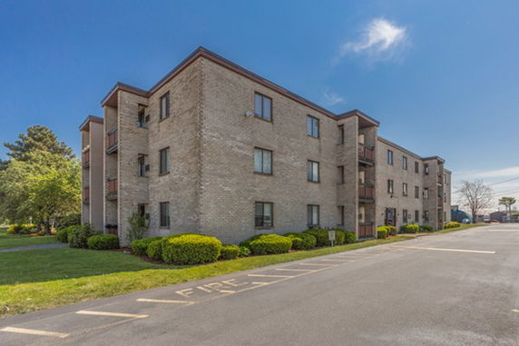 Front view of a multi-story brick apartment building.