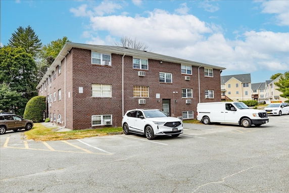 Front view of a three-story brick apartment building.