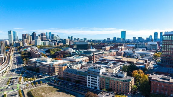 Panoramic view of a cityscape with multiple buildings and a clear sky.