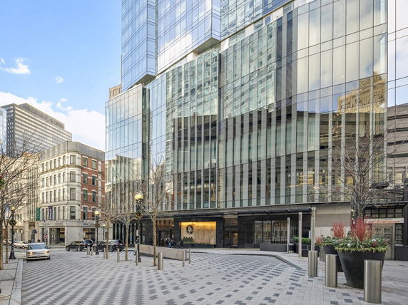 Front view of a modern glass building in an urban setting.