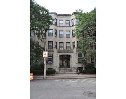 Front view of a multi-story residential building with multiple windows.
