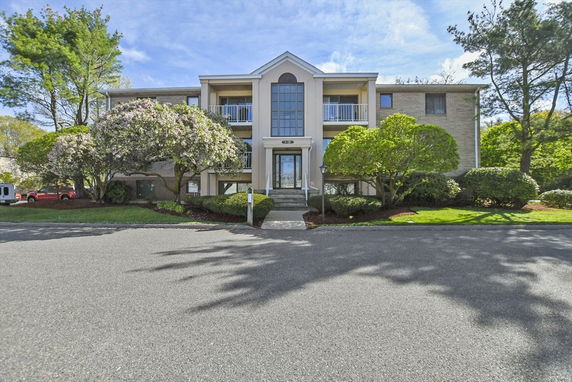 Front view of a two-story residential building with a central entrance.