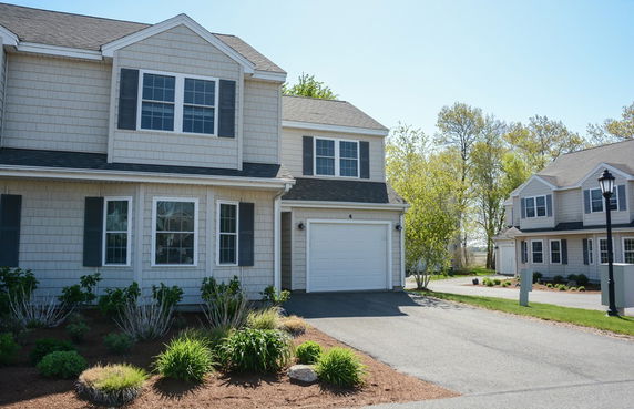 Front view of a two-story house with an attached garage.