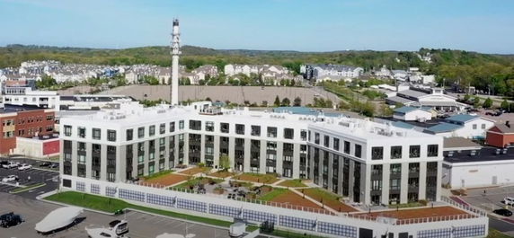 Front view of a large multi-story building with modern architecture.