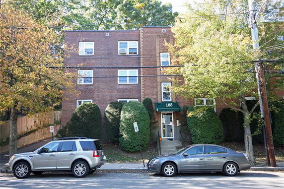Front view of a multi-story brick apartment building.