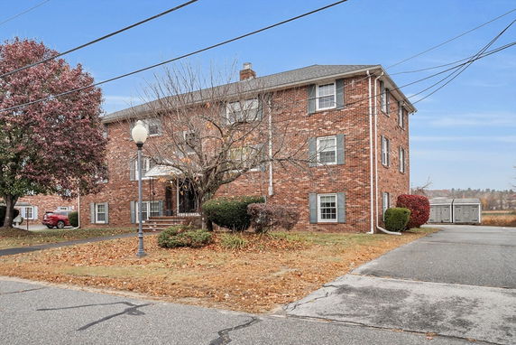 Front view of a three-story brick apartment building.