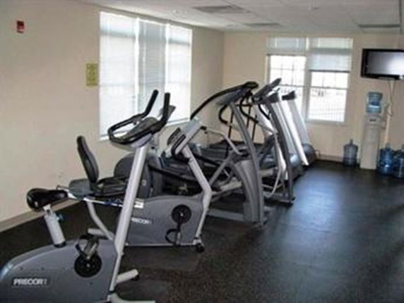 Indoor gym area with exercise equipment including stationary bikes and treadmills.