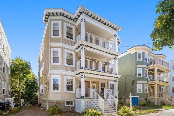 Front view of a multi-story residential building with balconies.