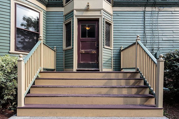 Front view of a house with wooden steps and a small porch.