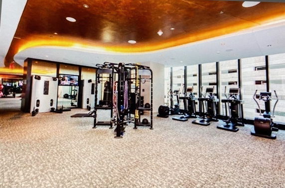 Indoor gym area with exercise equipment and modern lighting.