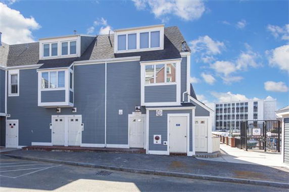 Front view of a multi-story house with a blue facade and white trim.