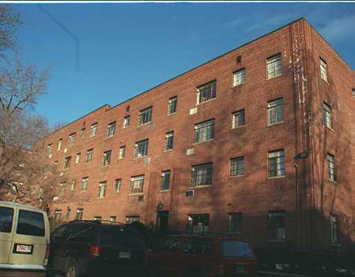 Front view of a multi-story brick apartment building.