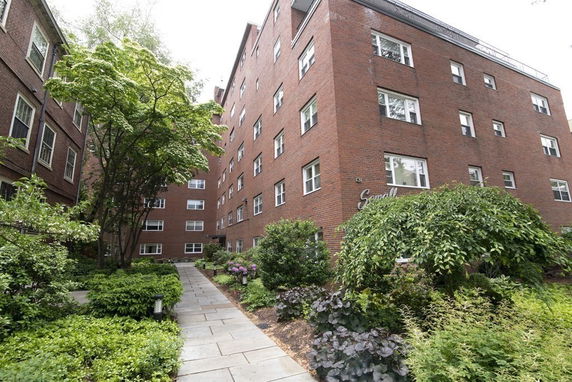 Front view of a multi-story brick apartment building.