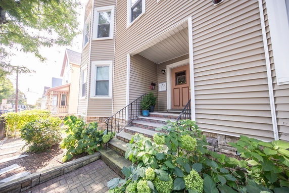 Front view of a house with a small entryway and steps.