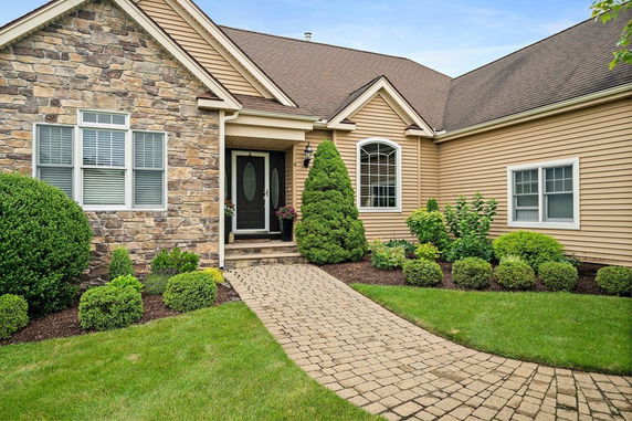Front view of a single-story house with stone and siding exterior.