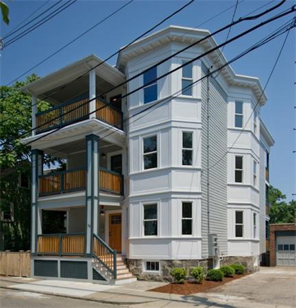 Front view of a multi-story house with multiple balconies.