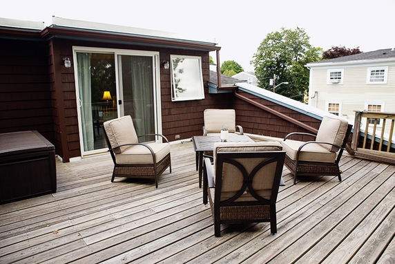Rooftop seating area with chairs and a table.