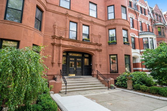 Front view of a classic brick building with ornate architectural details.