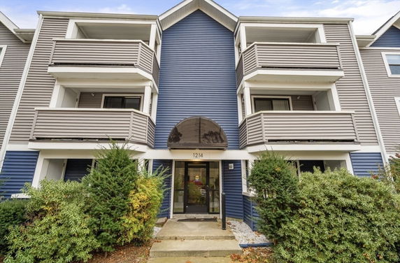 Front view of a multi-story residential building with balconies.