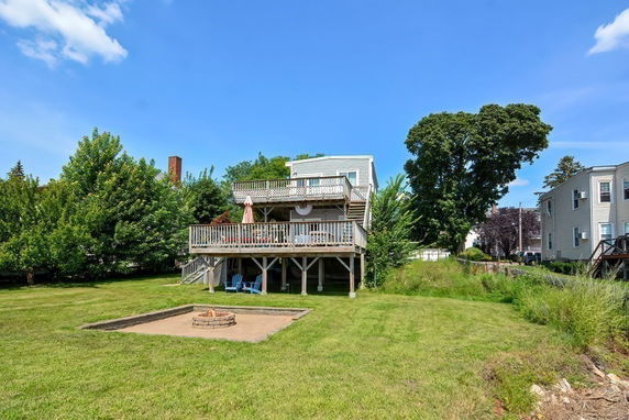 Rear view of a two-story house with wooden decks.