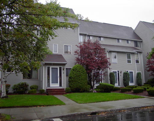 Front view of a multi-story house with a landscaped entrance.