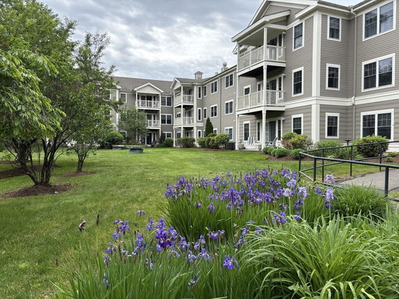 Front view of a multi-story residential building with balconies.