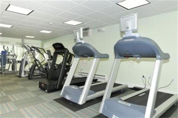 Indoor gym with treadmills and exercise machines.