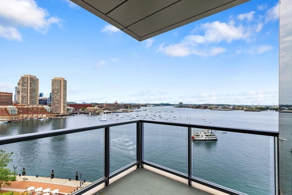 Panoramic view of waterfront and cityscape from a balcony.