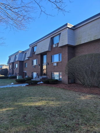 Front view of a multi-story brick residential building.