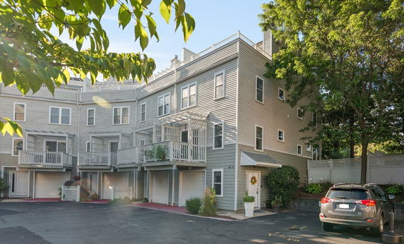 Front view of a multi-story residential building with balconies.