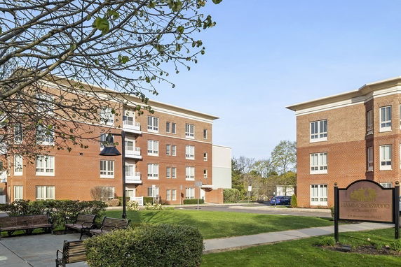 Front view of a multi-story brick apartment building complex.