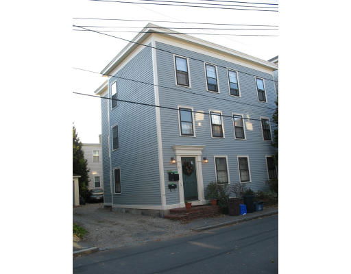Front view of a multi-story house with a blue facade and rectangular windows.