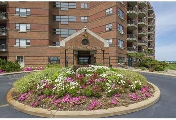 Front view of a multi-story brick building with balconies.