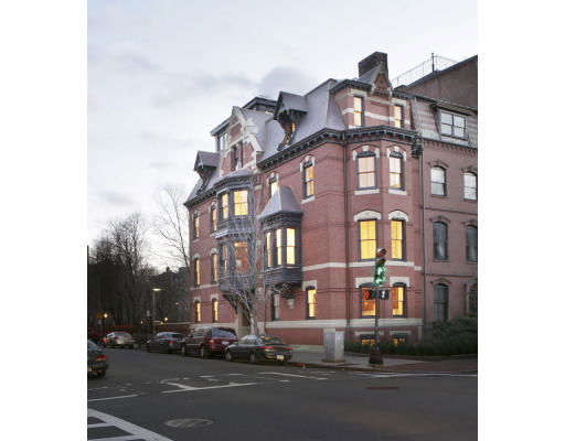 Front view of a multi-story brick building with ornate architectural details.